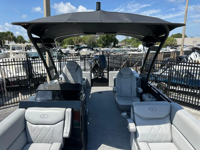 Slide: The Image of 2025 Veranda VX 25 RC pontoon boat with luxurious seating and canopy, docked under a sunny sky. - 10