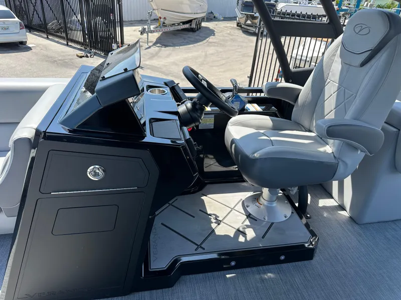 Slide: The Image of 2025 Veranda VX 25 RC boat helm with sleek black console and comfortable captain's chair. - 11