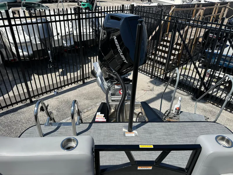 Slide: The Image of 2025 Veranda VX 25 RC boat with Mercury engine, docked near a fenced area. - 16