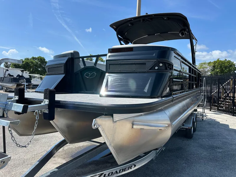 Slide: The Image of 2025 Veranda VX 25 RC pontoon boat on trailer, sleek design, sunny day. - 3