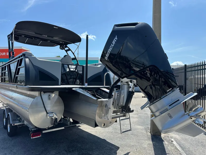 Slide: The Image of 2025 Veranda VX 25 RC pontoon boat with Mercury outboard motor, parked on a trailer. - 4