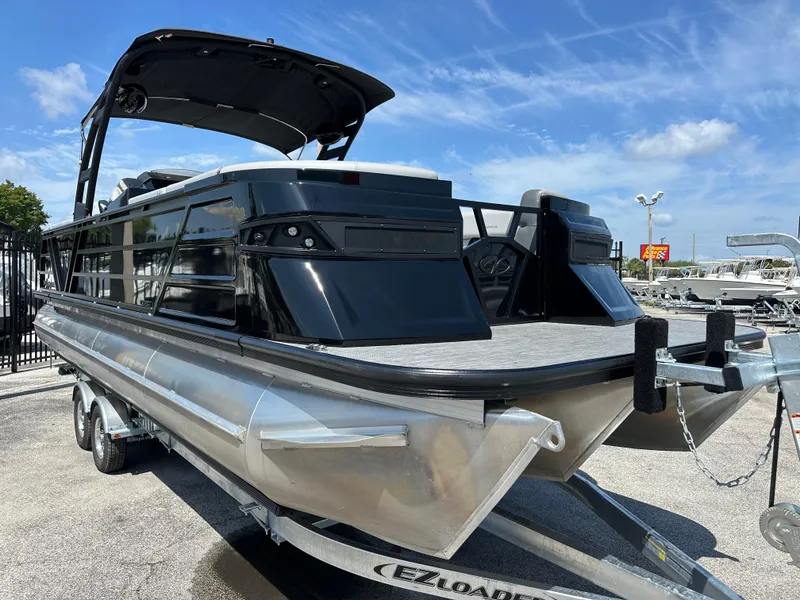Slide: The Image of 2025 Veranda VX 25 RC pontoon boat on trailer under blue sky. - 5
