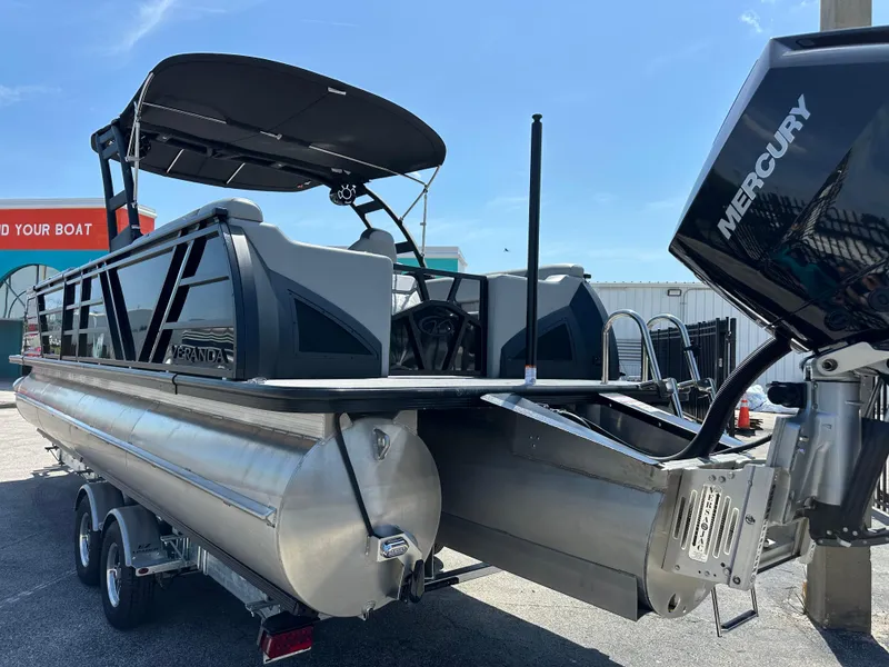 Slide: The Image of 2025 Veranda VX 25 RC pontoon boat with Mercury engine, parked on a trailer. - 6