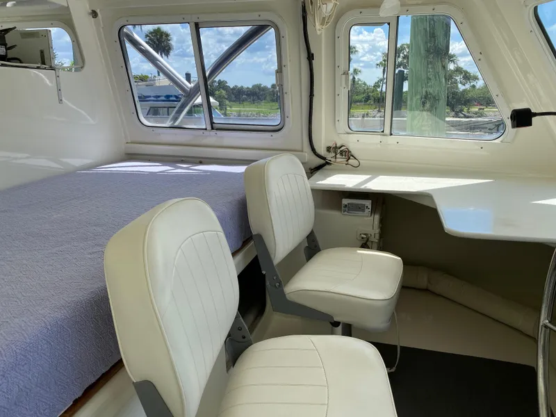 Slide: The Image of Interior of a 1996 Custom 62 boat with seating and windows. - 19