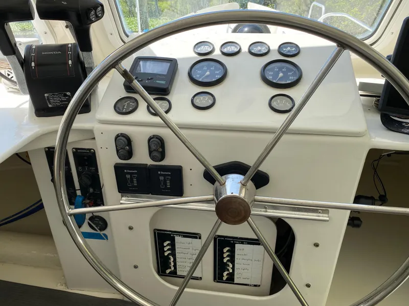 Slide: The Image of Boat steering wheel and control panel with gauges, Custom 62 model, 1996. - 20