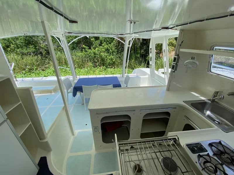 Slide: The Image of Interior of a 1996 Custom 62 boat with kitchen and dining area. - 25
