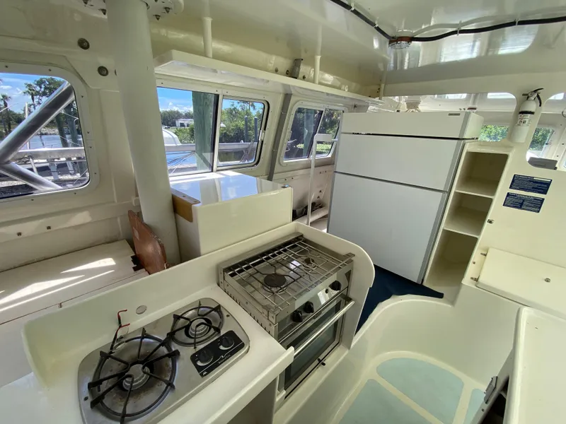 Slide: The Image of Interior of a 1996 Custom 62 yacht kitchen with stove, oven, and refrigerator. - 27