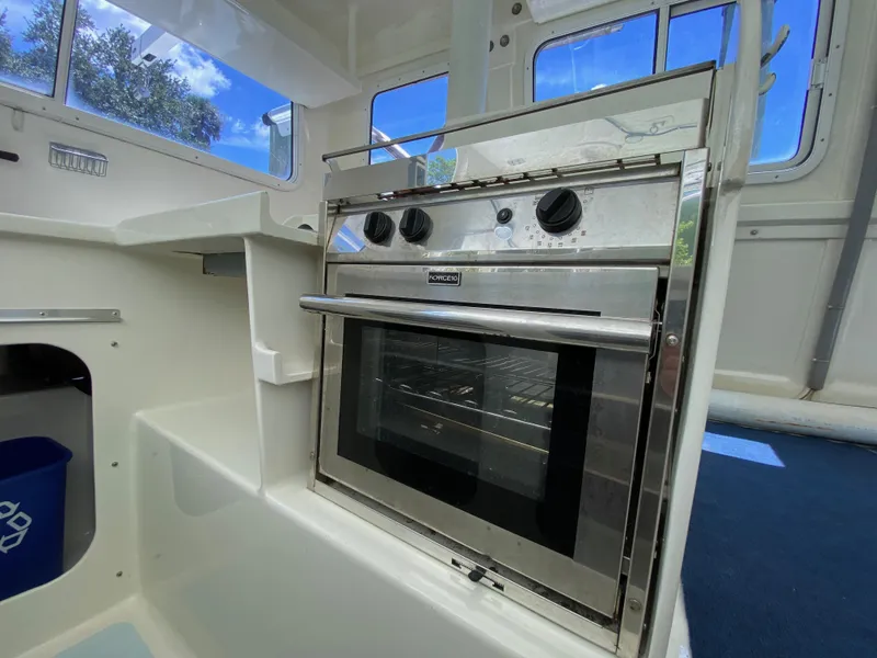 Slide: The Image of Stainless steel oven in a boat's compact kitchen, Custom 62 model, 1996. - 29
