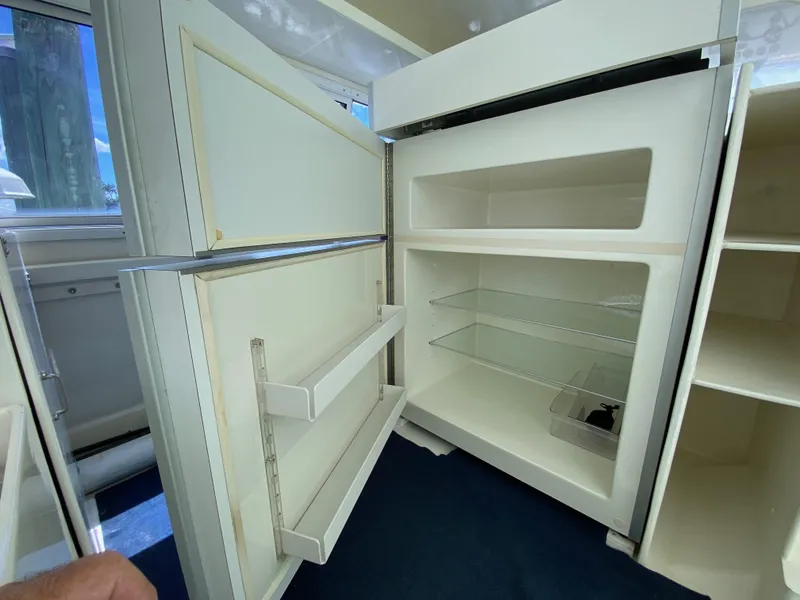 Slide: The Image of Open custom refrigerator, model 62, from 1996, with empty shelves and door compartments. - 33