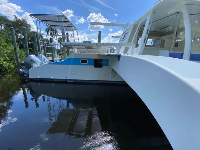 Slide: The Image of Custom 1996 model 62 boat docked on a sunny day with clear skies. - 35