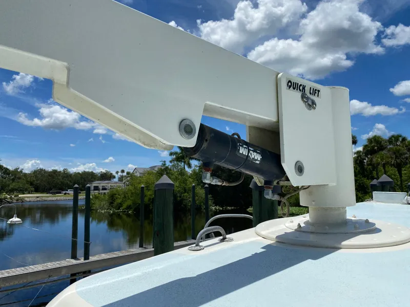 Slide: The Image of Custom 62 boat with solar panels, docked in a lush, green riverside setting, under a blue sky. - 40
