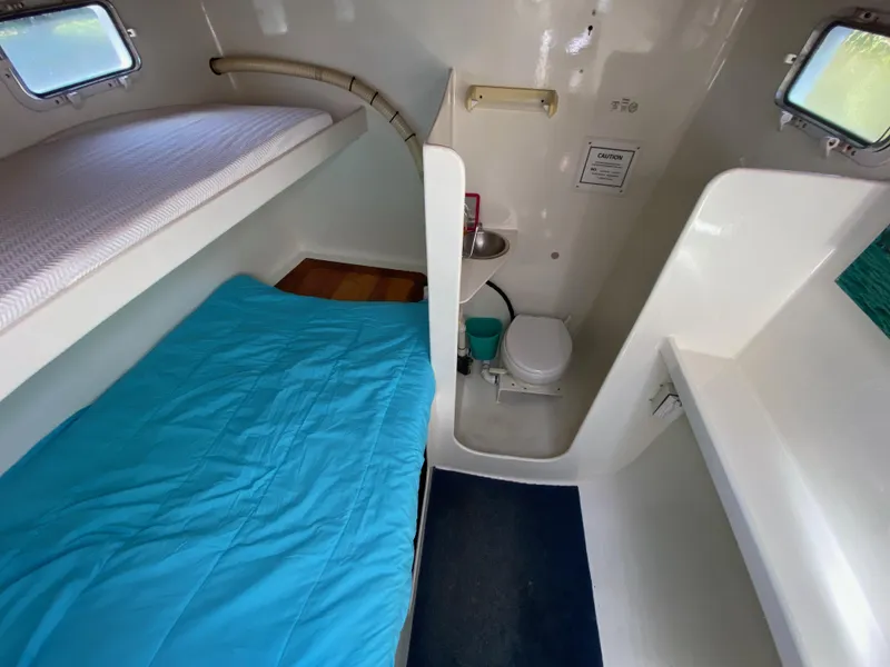 Slide: The Image of Compact marine bathroom with toilet, sink, and storage in a 1996 Custom model 62 boat. - 47