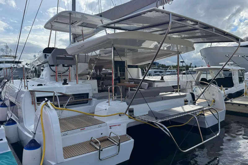 Slide: The Image of 2026 Lagoon 43 yacht docked, showcasing sleek design and spacious deck area. - 10