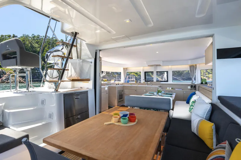 Slide: The Image of Luxurious interior of 2026 Lagoon 43 yacht with modern dining and seating area. - 13