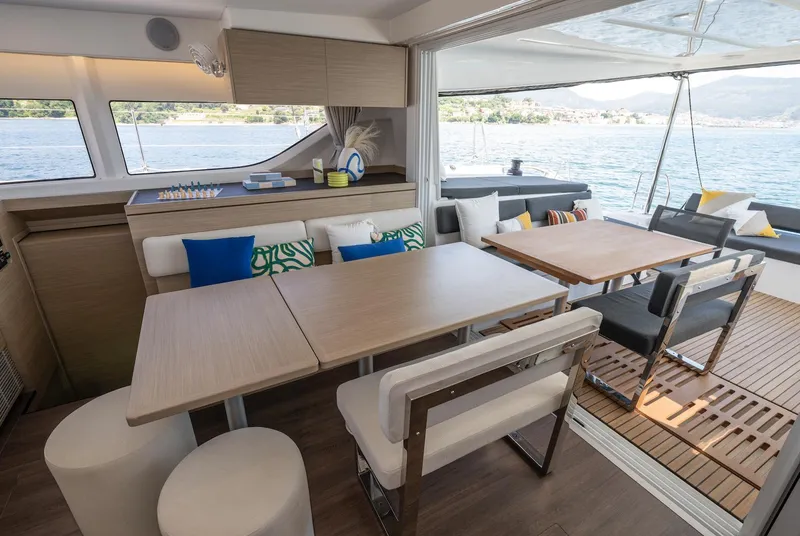 Slide: The Image of Luxurious interior of 2026 Lagoon 43 yacht with elegant dining area and scenic ocean view. - 15