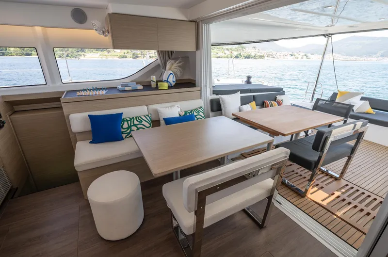 Slide: The Image of Luxurious interior of 2026 Lagoon 43 yacht with modern dining area and scenic ocean view. - 16