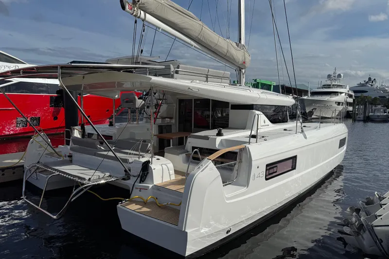Slide: The Image of 2026 Lagoon 43 catamaran docked at marina, showcasing sleek design and modern features. - 2