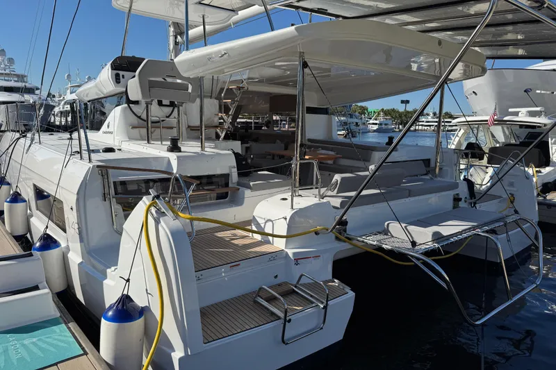 Slide: The Image of 2026 Lagoon 43 yacht docked, featuring spacious deck and modern design. - 20