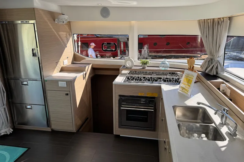 Slide: The Image of Modern kitchen interior of 2026 Lagoon 43 yacht with stainless steel appliances and sleek countertops. - 23