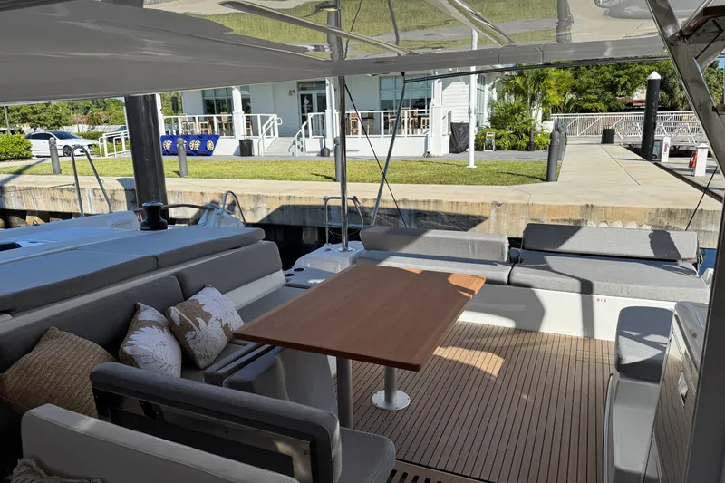 Slide: The Image of Luxurious 2026 Lagoon 43 yacht interior with elegant seating and wooden table at dock. - 40