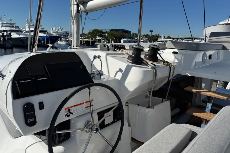 Slide: The Image of Helm of 2026 Lagoon 43 yacht with modern navigation equipment and seating. - 41