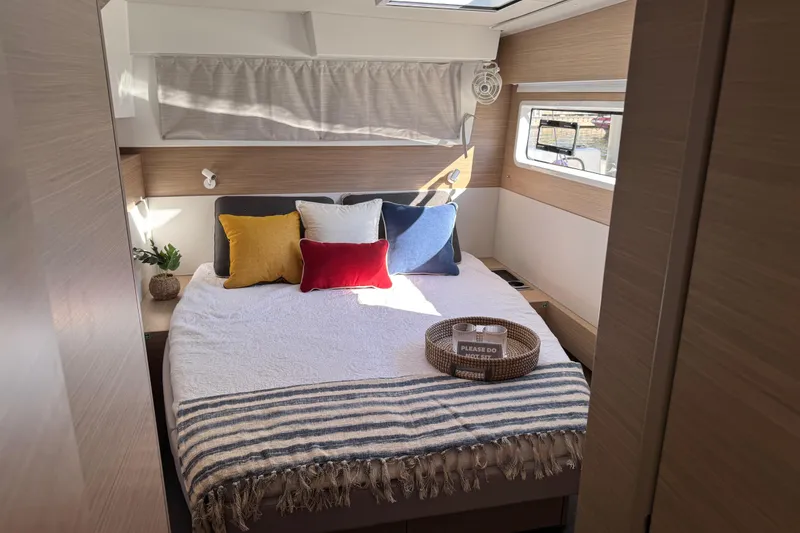 Slide: The Image of Luxurious bedroom interior of 2026 Lagoon 43 yacht with cozy bedding and natural light. - 47