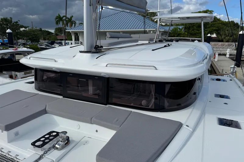 Slide: The Image of 2026 Lagoon 43 yacht with sleek design, docked under cloudy skies. - 5