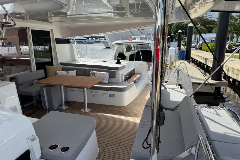 Slide: The Image of Luxurious 2026 Lagoon 43 yacht interior with elegant seating and dining area at the dock. - 9