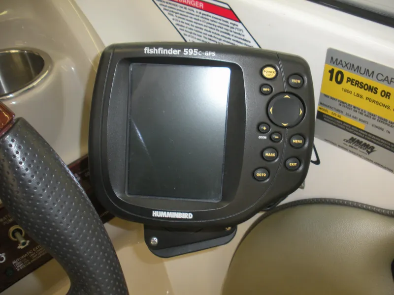 Slide: The Image of Humminbird fishfinder on 2007 Sea Ray 220 Sundeck dashboard, maximum capacity label visible. - 11