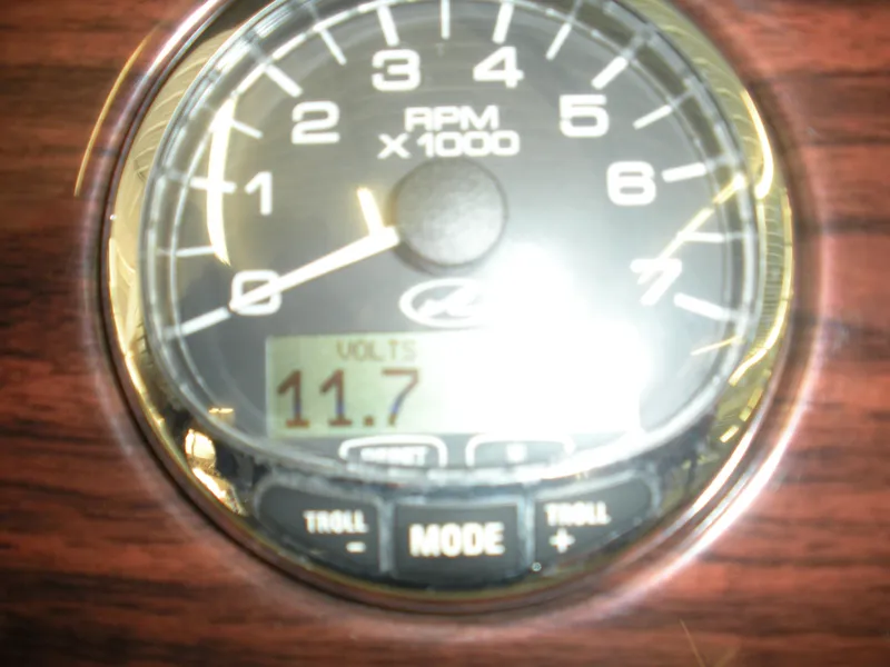 Slide: The Image of Close-up of a 2007 Sea Ray 220 Sundeck tachometer displaying 11.7 volts. - 12
