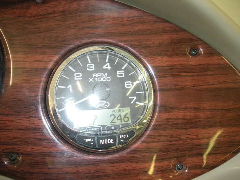 Slide: The Image of Tachometer of 2007 Sea Ray 220 Sundeck showing 246 hours on wooden dashboard. - 13