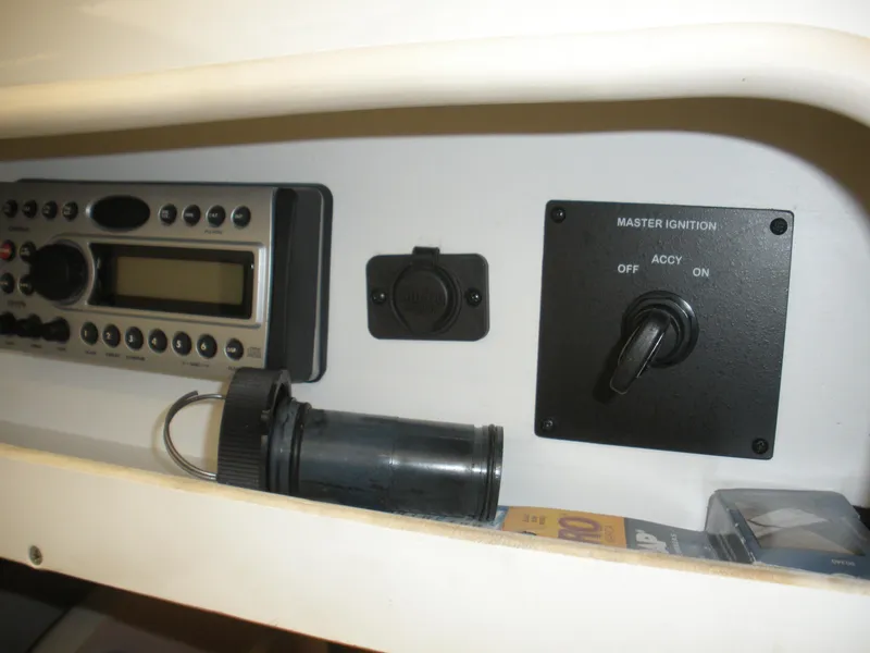 Slide: The Image of Control panel of a 2007 Sea Ray 220 Sundeck with ignition switch and radio. - 17