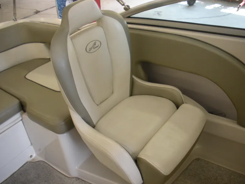 Slide: The Image of Captain's seat in 2007 Sea Ray 220 Sundeck boat, beige and gray upholstery. - 19