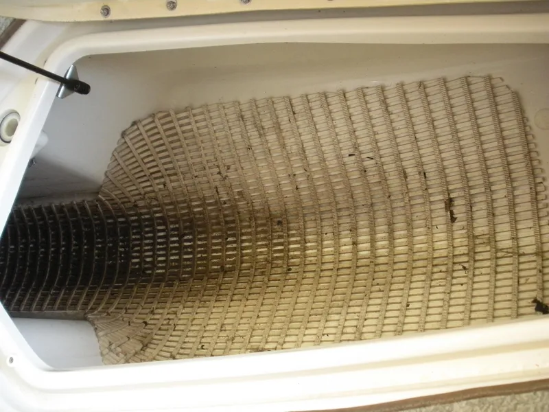 Slide: The Image of Storage compartment of a 2007 Sea Ray 220 Sundeck boat with a textured mat. - 22