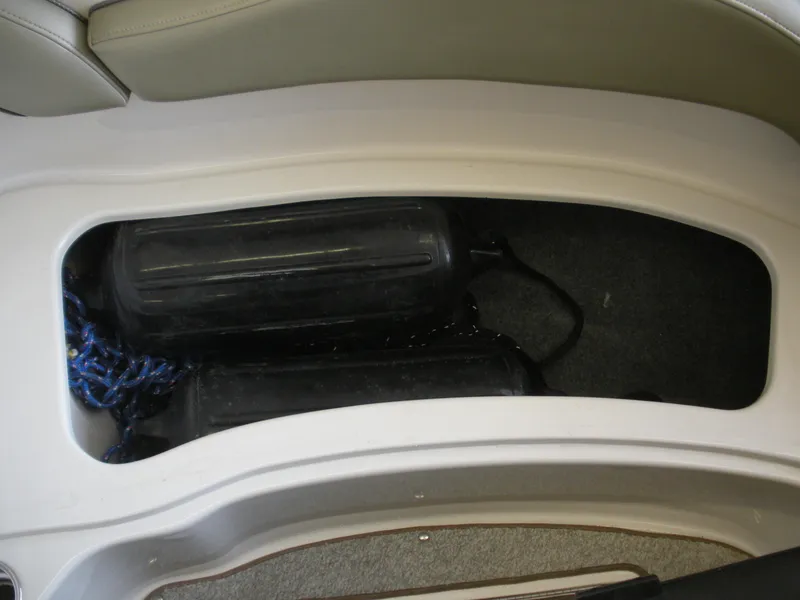 Slide: The Image of Storage compartment in a 2007 Sea Ray 220 Sundeck boat with fenders and rope. - 24