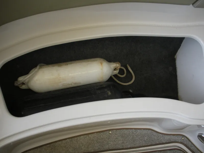 Slide: The Image of Storage compartment in a 2007 Sea Ray 220 Sundeck with a boat fender inside. - 25