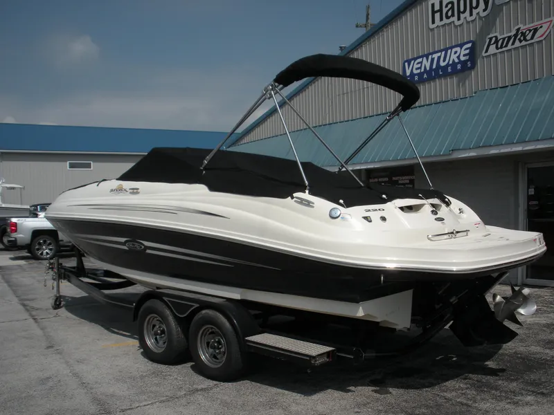 Slide: The Image of 2007 Sea Ray 220 Sundeck boat on trailer, parked outside dealership. - 30