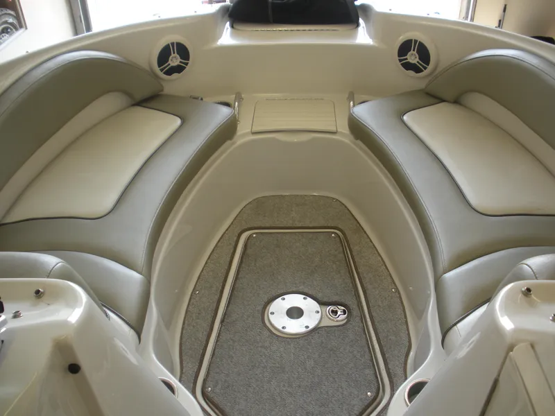 Slide: The Image of 2007 Sea Ray 220 Sundeck interior with cushioned seating and carpeted flooring. - 6