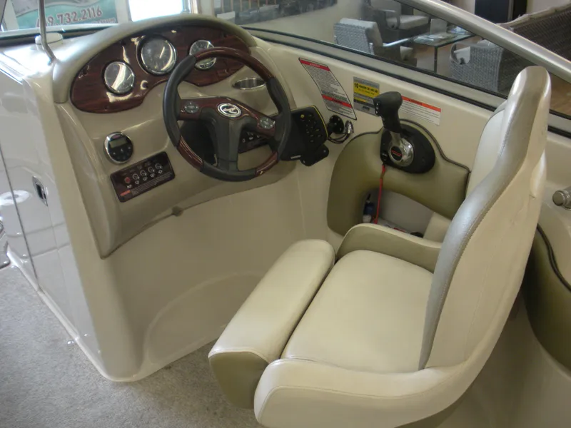 Slide: The Image of 2007 Sea Ray 220 Sundeck helm with steering wheel and control panel. - 7
