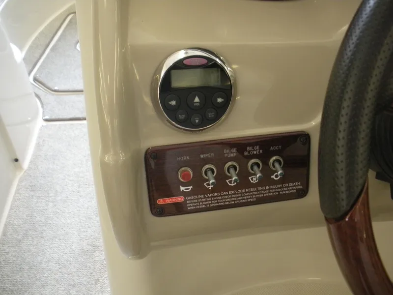 Slide: The Image of Control panel of a 2007 Sea Ray 220 Sundeck boat with switches and warning label. - 8