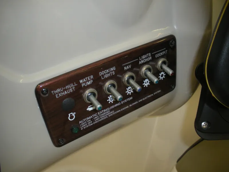 Slide: The Image of Control panel of a 2007 Sea Ray 220 Sundeck boat with labeled switches. - 9