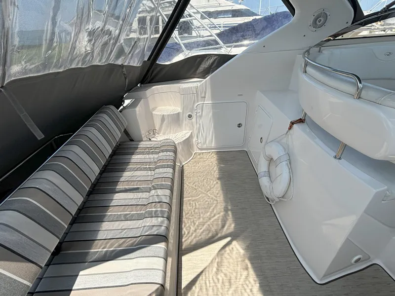 Slide: The Image of Interior of 2006 Regal Commodore 3560 IO boat with striped seating and life preserver. - 13