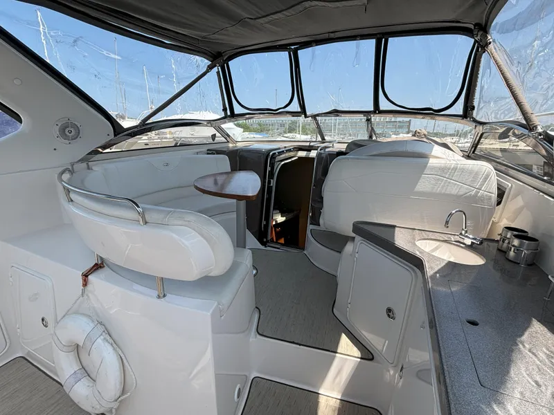 Slide: The Image of 2006 Regal Commodore 3560 IO yacht interior with seating, table, and kitchenette. - 14