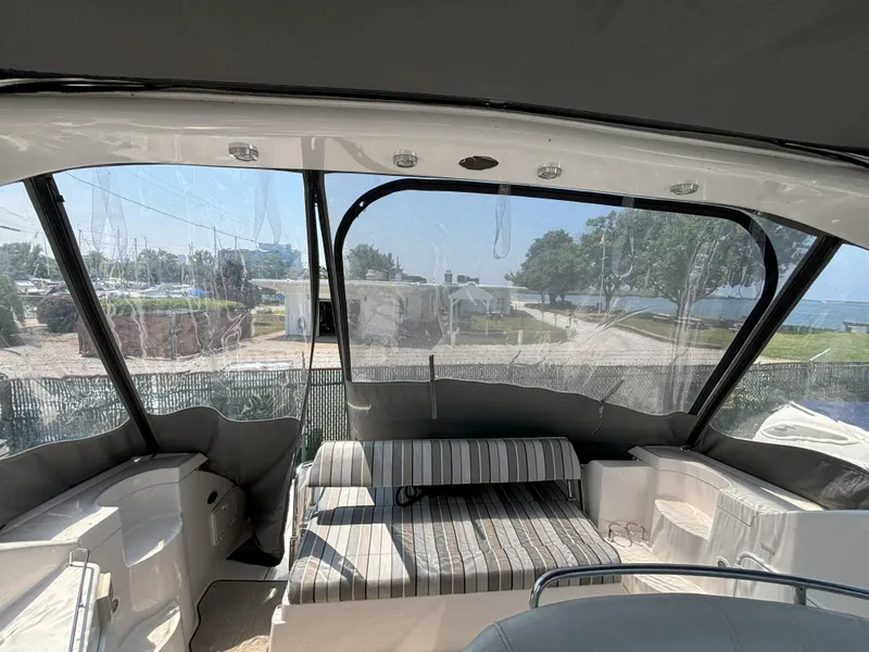 Slide: The Image of 2006 Regal Commodore 3560 IO boat interior with striped seating and clear canopy. - 17