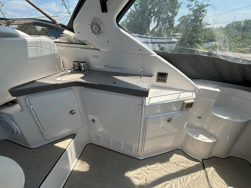 Slide: The Image of 2006 Regal Commodore 3560 IO yacht interior with kitchenette and seating area. - 19