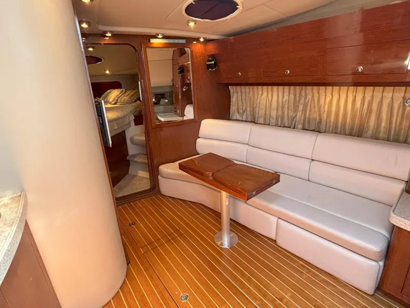 Slide: The Image of Luxurious interior of 2006 Regal Commodore 3560 IO yacht with wood flooring and plush seating. - 2