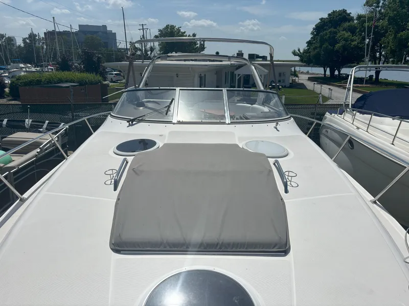 Slide: The Image of 2006 Regal Commodore 3560 IO boat docked, featuring spacious deck and sleek design. - 20