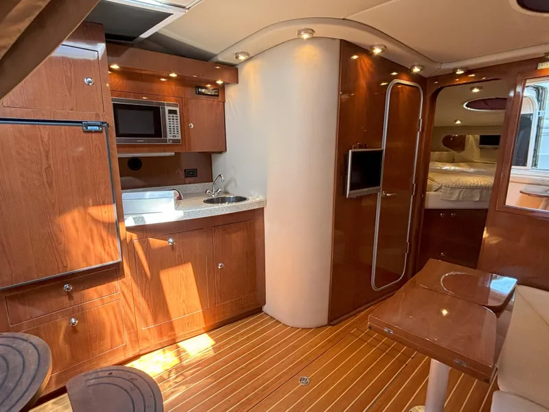 Slide: The Image of Luxurious interior of 2006 Regal Commodore 3560 IO yacht with wood finish and modern amenities. - 3
