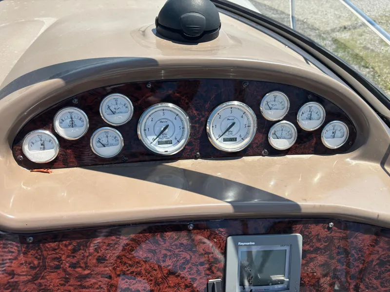 Slide: The Image of Dashboard of 2006 Regal Commodore 3560 IO boat with gauges and navigation display. - 32