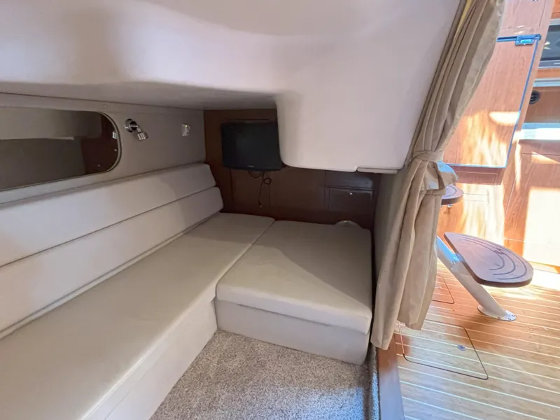 Slide: The Image of 2006 Regal Commodore 3560 IO cabin interior with beige seating and wooden flooring. - 36